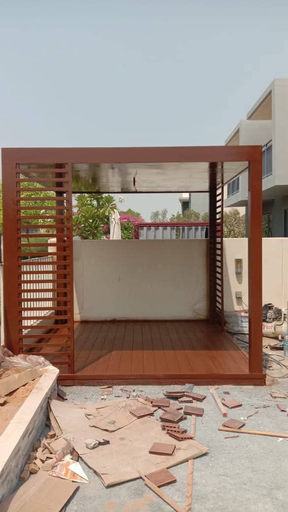 Timber gazebo under construction with a slatted screen