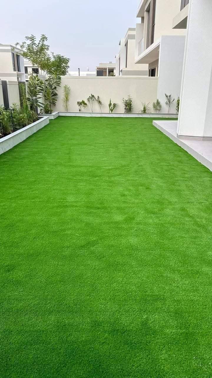 Fresh artificial lawn in a villa garden