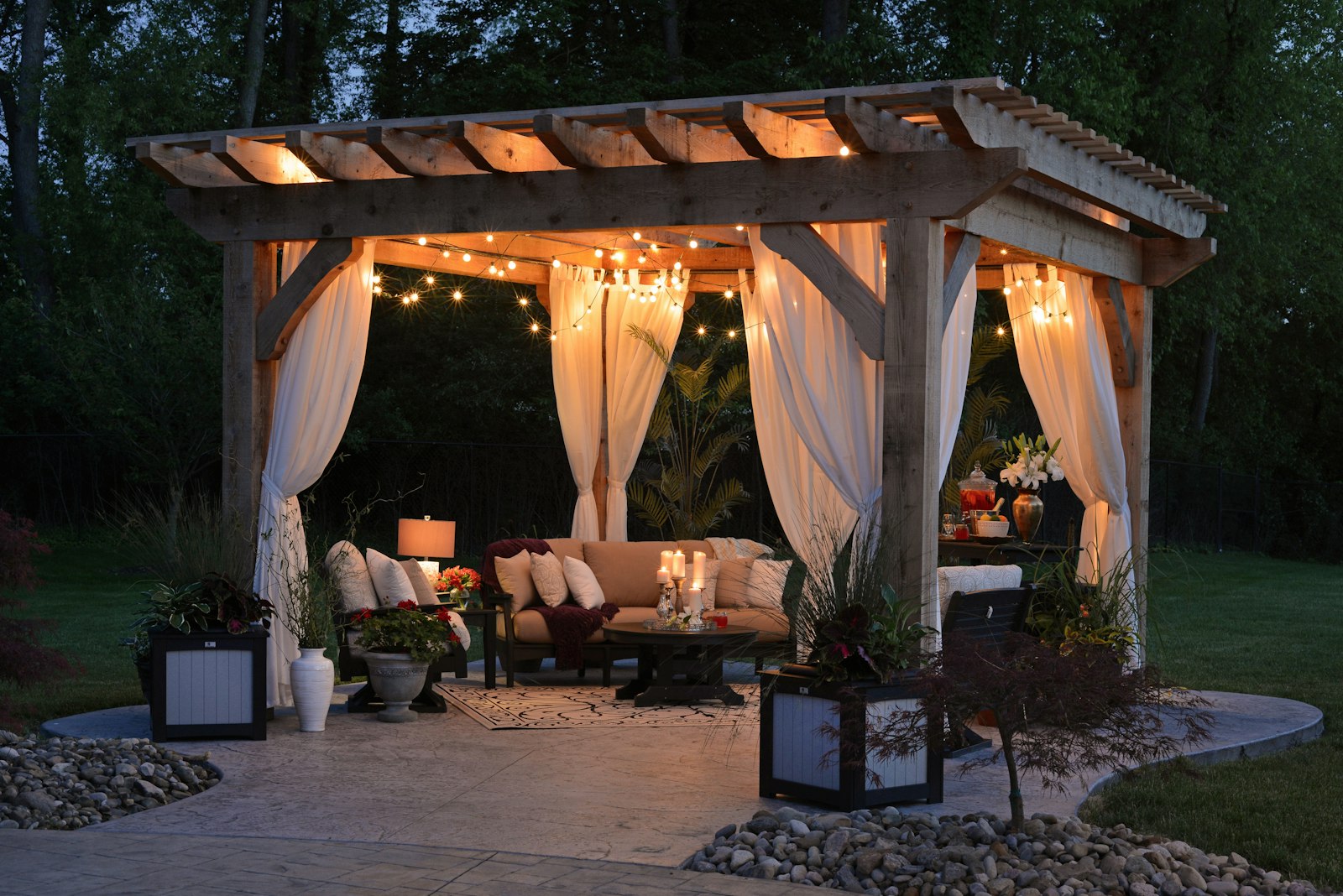 Timber gazebo with curtains and string lights