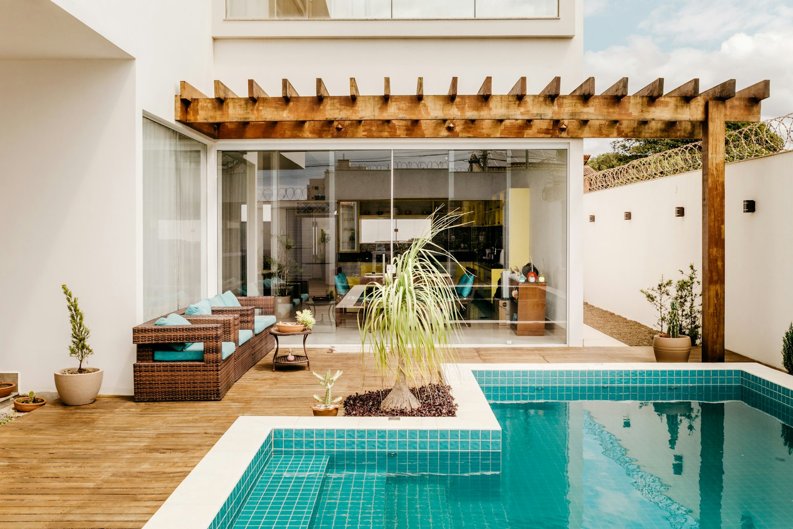 Timber pergola beside a tiled pool